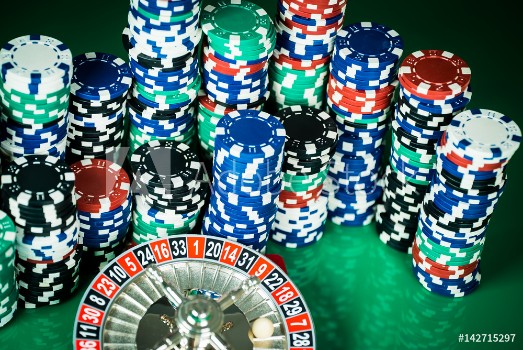 Picture of Poker Chips on a gaming table roulette Casino theme background